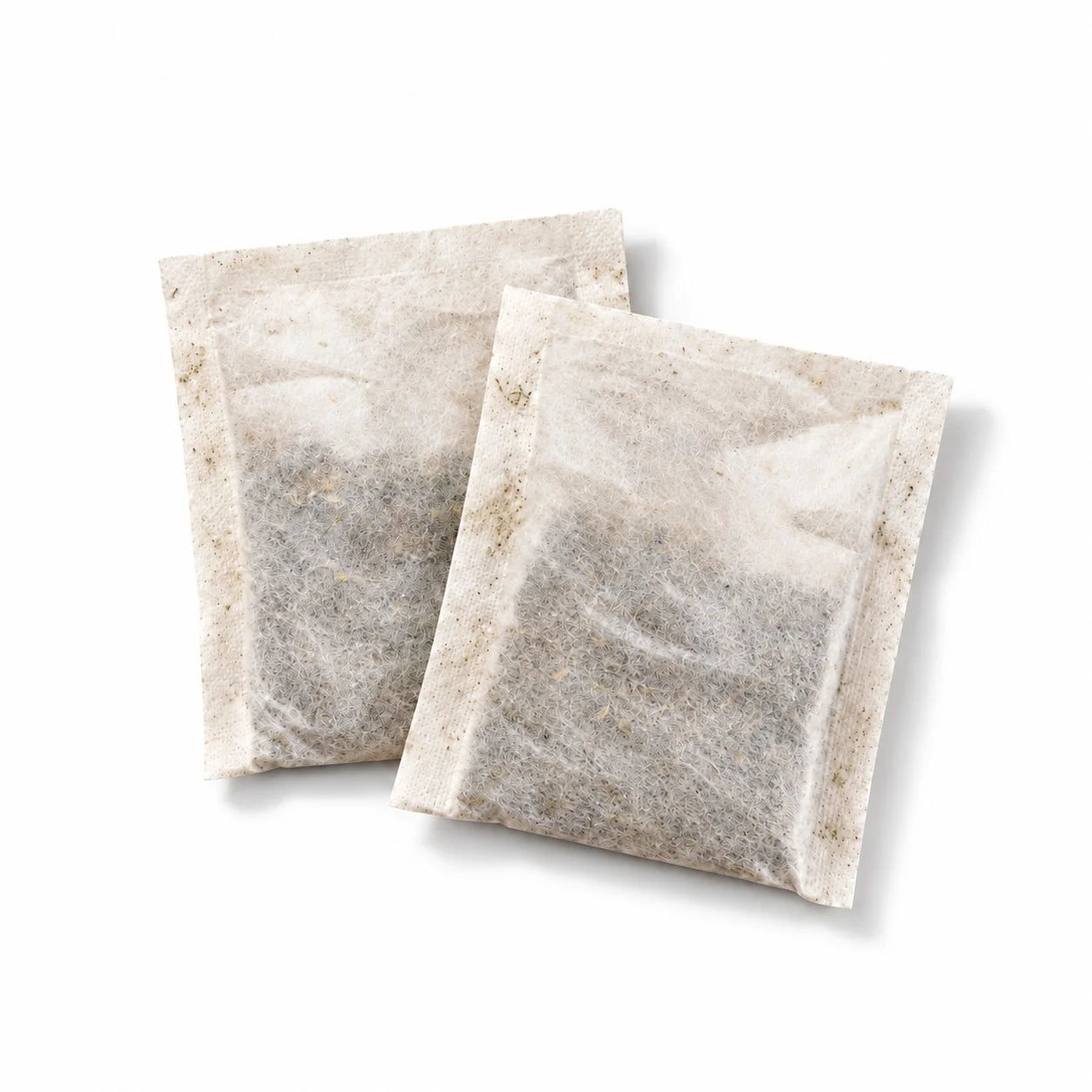 Two soursop leaf brewing sachets on a white background.