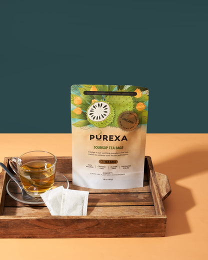 PUREXA soursop tea bags with a glass of tea on a wooden tray against a green and orange gradient background