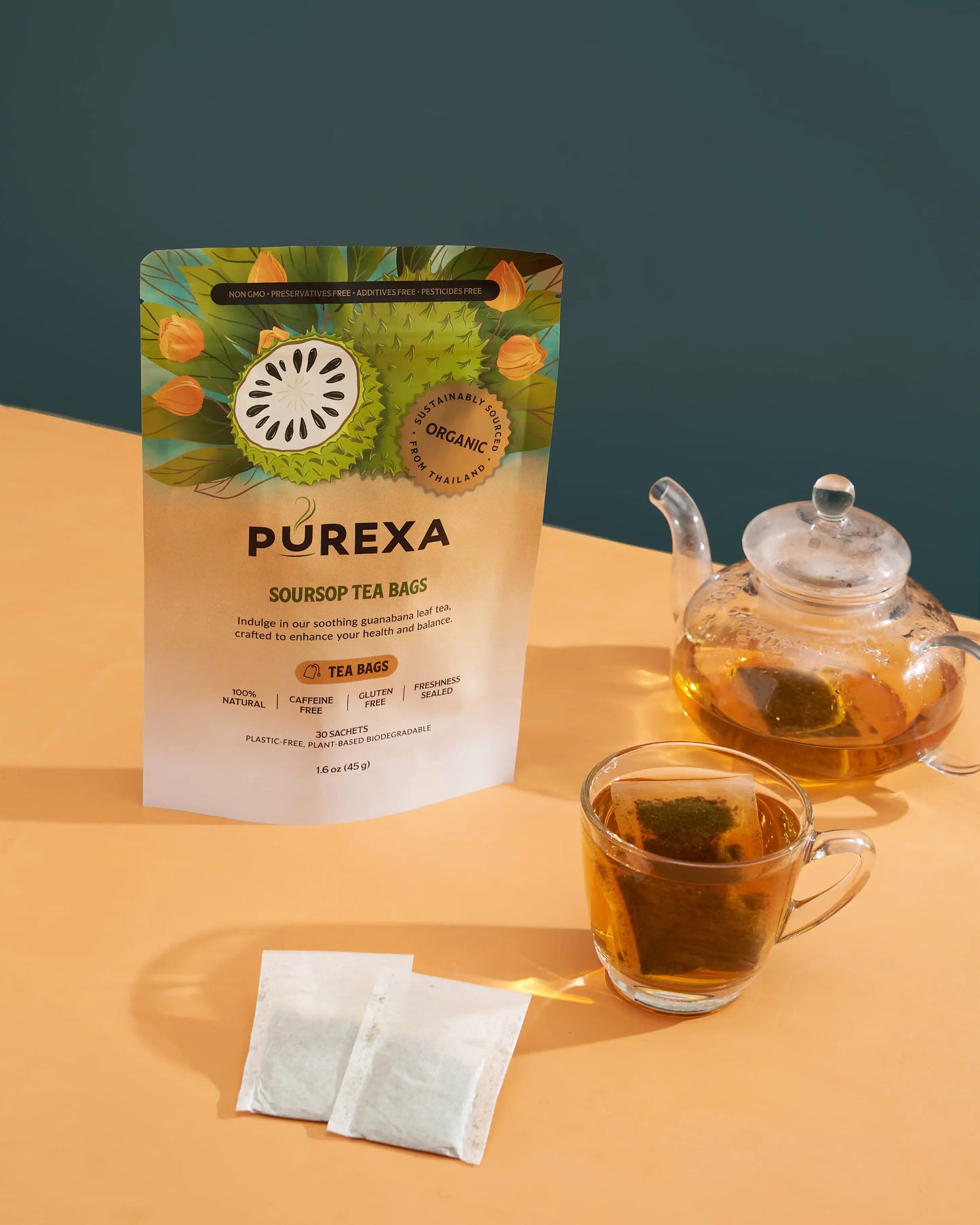 PUREXA Organic Soursop Tea Bags pouch with a steeping sachet, glass cup, and teapot